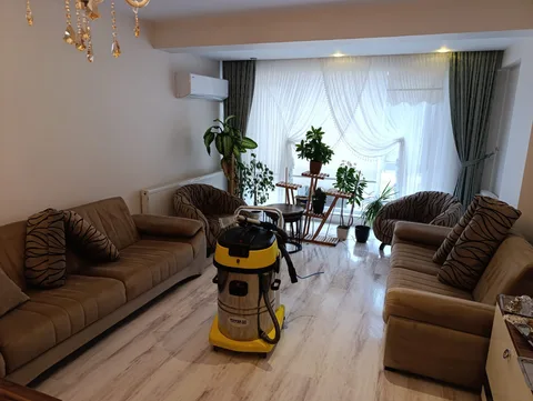 Kahverengi koltuk takımı ve yerinde temizlik ekipmanı